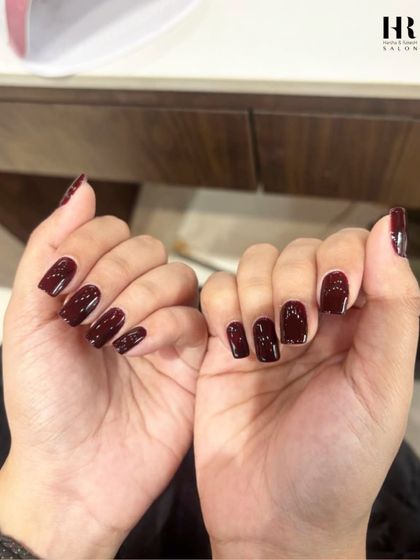A classic color with a modern twist. This deep, vampy burgundy polish has a rich, glossy finish that is perfect for a sophisticated yet bold statement on perfectly shaped square nails.