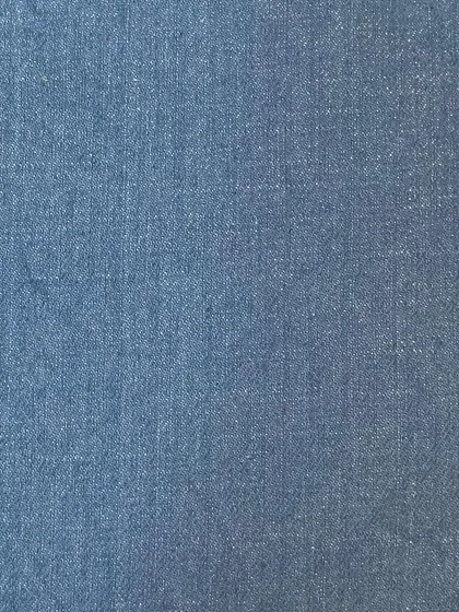 A swatch of light blue chambray-like denim. This lightweight fabric is perfect for comfortable summer jeans or a custom denim shirt.