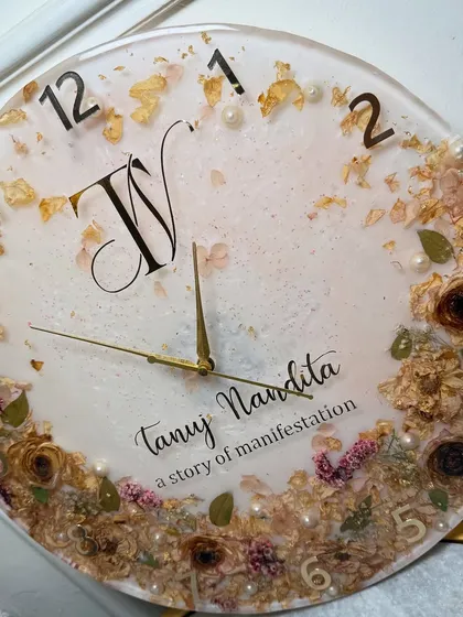 An angled view of the custom resin clock, highlighting the depth and the way the light catches the gold flakes and glossy surface.