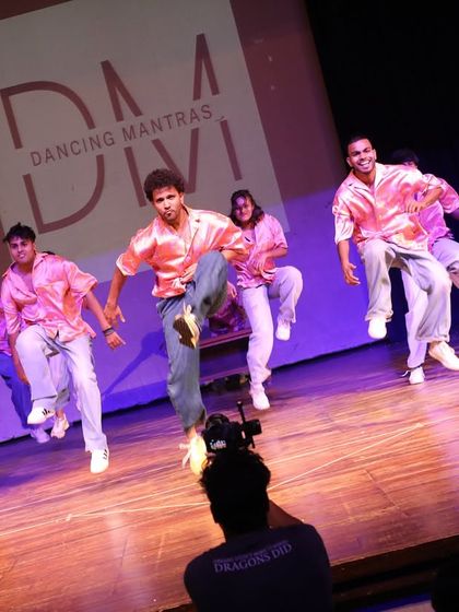 A high-energy, mid-air shot of our boys' crew during their performance. This captures the explosive energy and fun they bring to the stage with their Bollywood and hip-hop fusion dance.