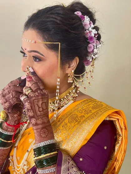 Adjusting the traditional Marathi nath. It's these small details that complete the entire bridal look and make it authentic.