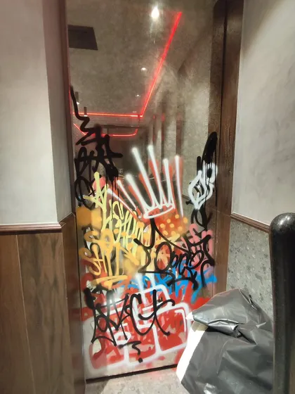 Even the doors get a hit. A chaotic and colorful mix of tags and styles on a glass door, adding to the raw, street-art atmosphere of the commercial space.