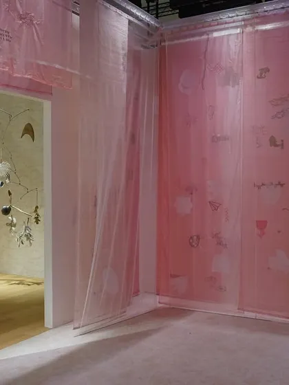A wider view of the 'Feel More' installation, showing the interplay of pink and green translucent panels. The soft gradients of color conjure a hazy, abstract landscape where tranquility meets intrigue.