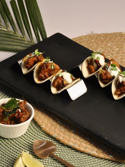 My Chicken Ghee Roast Tacos are a fusion of Mangalorean and Mexican cuisines. The rich and spicy chicken ghee roast is served in a soft taco for a unique and delicious bite.