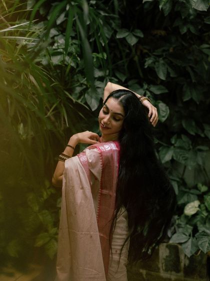 A gentle, flowing pose amidst lush greenery, highlighting my long hair.