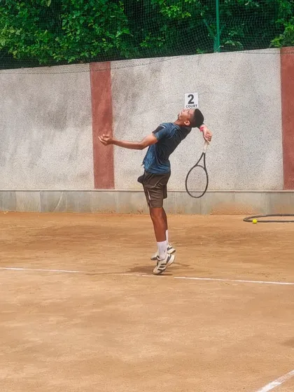 The serve is a weapon, and we forge it through thousands of repetitions. This is one of our U-16 players perfecting his service motion during a practice session for an AITA tournament on our clay court.