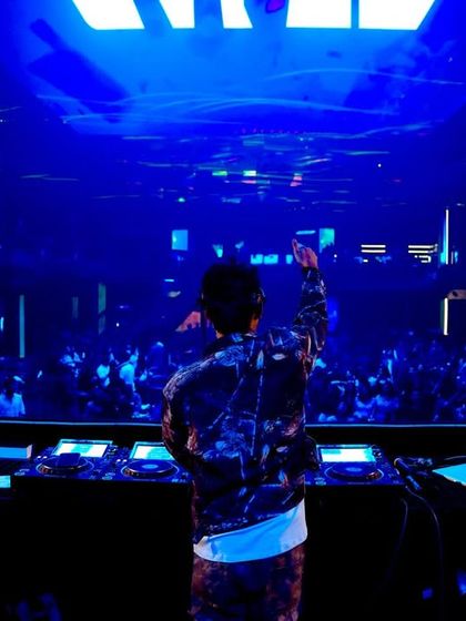 A view from behind the decks at a club in Hyderabad, looking out at the packed dance floor.
