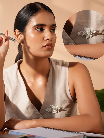 Our pearl leaf brooch adds a touch of royalty to this modern office look.