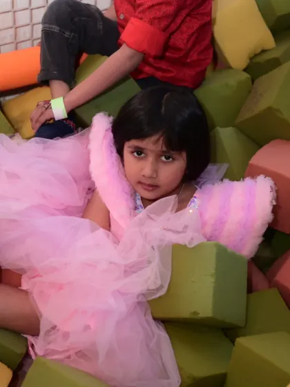 A birthday girl looking like a princess in our foam block pit. Even in the middle of play, she looks magical.