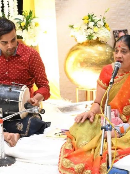 We arrange for live traditional music, like this dholak player and singer, to create an authentic and celebratory atmosphere during the Mehendi.
