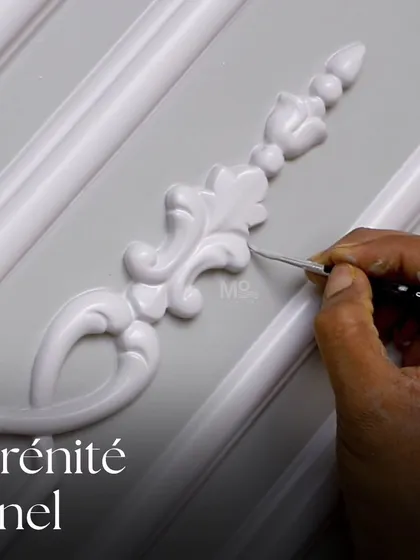 True luxury is in the details. Here, our artisan is perfecting the Sérénité Panel, a piece inspired by the calm elegance of neoclassical decor. This level of meticulous hand-crafting ensures every custom wall panel we create is a unique masterpiece of symmetry and character.