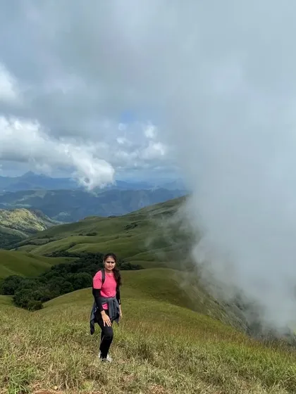 Another shot of a trekker enjoying the magnificent views as clouds roll in over the valley.