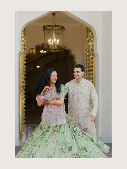 A joyful, spontaneous moment at the entrance of the palace. The bride's twirl and the couple's laughter make this pre-wedding photo feel authentic and full of happiness.