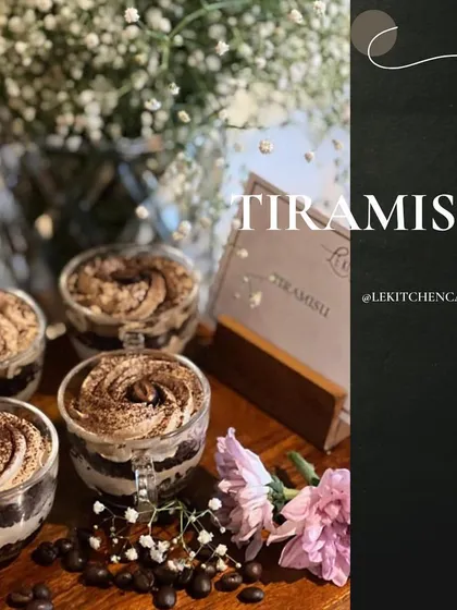 Our classic Tiramisu, served in charming glass mugs and surrounded by fresh flowers and coffee beans.