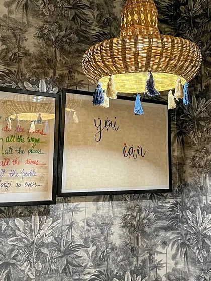 Here are two of my favorite upcycled creations side by side. The hanging lamp is made from a cane basket I found at a local Bangalore market, decorated with tassels. Next to it is a custom artwork I made using leftover wallpaper and IKEA frames to cleverly hide my home's MCB board.