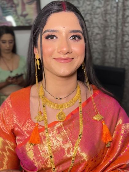 A beautiful Maharashtrian bride with a simple and elegant makeup look. The focus is on her natural beauty, with a soft base and a traditional bindi.