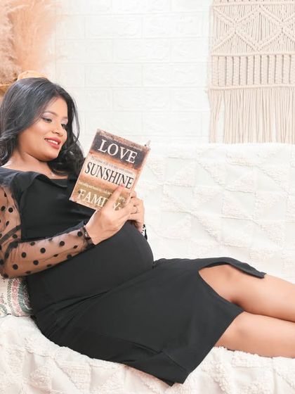 A quiet, peaceful moment of a mom-to-be relaxing and reading. This lifestyle portrait captures the calm and introspective side of pregnancy.