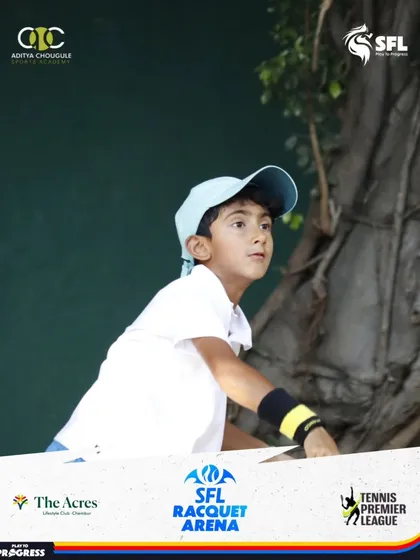 A young player prepares to serve, demonstrating the concentration we instill in our athletes from an early age. This is where champions begin their journey.