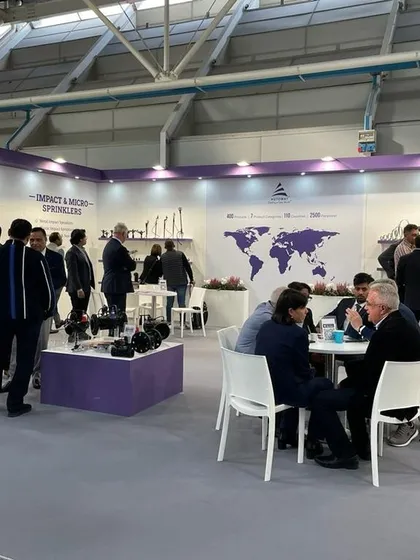 A wide shot of our busy booth at the EIMA International expo in Bologna, Italy. Our global map display highlights our presence in over 110 countries, attracting visitors from around the world.