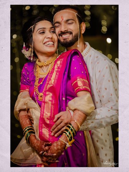 A classic portrait of the happy couple, her in a stunning purple Paithani saree.
