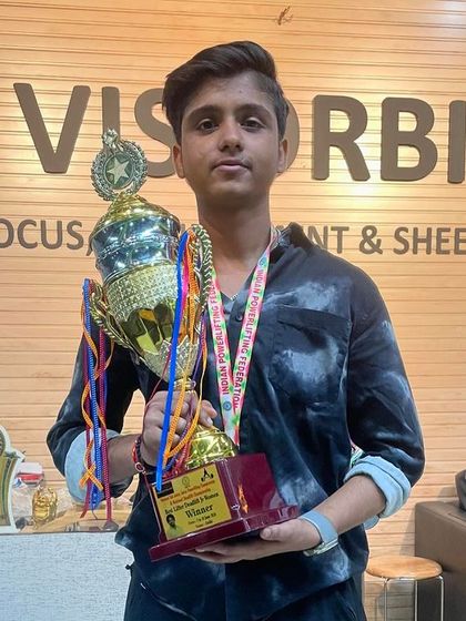 One of our junior lifters with his well-earned trophy. The future of our team is strong.