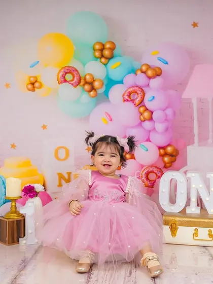 A sweet and simple portrait from the same candy-themed shoot. The soft lighting and pastel colors create a dreamy look for this first birthday memory.