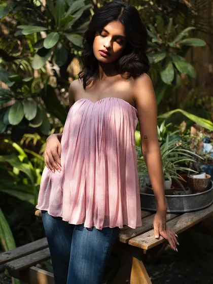 A soft and romantic summer portrait for It Girl. The pink pleated top and the model's gentle expression create a dreamy mood.