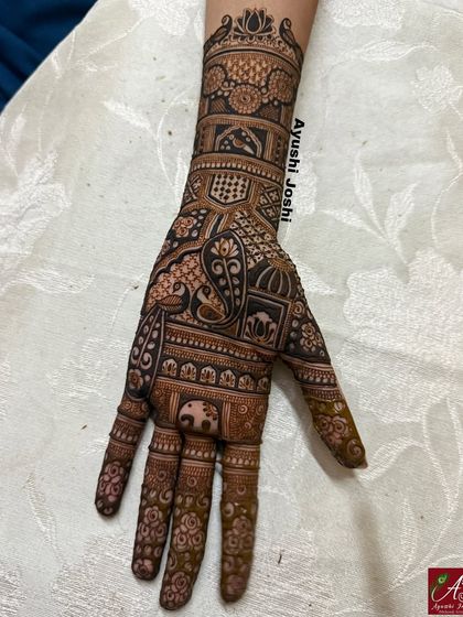 A close-up of the detail in this engagement mehendi, showing a mix of paisley, peacock, and elephant motifs.