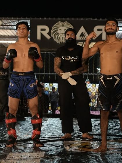 The coach and his fighters after the war. A moment of pride and reflection in the octagon with South Asia Bantamweight champion Chungreng Koren.