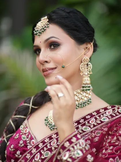 The bride looking away, showcasing the beautiful side profile and the intricate braided hairstyle.