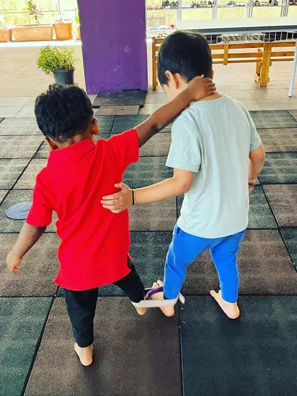 This partner activity focuses on cooperation and communication. Two boys learn to work together, synchronizing their steps to build teamwork skills in a simple and effective challenge.