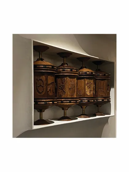 In a transitional passageway, we commissioned this sculpture inspired by Buddhist prayer wheels. The meticulously executed piece is a modern take on the wheels, depicting the life of Shiva. It invites a moment of interaction and reflection as you move through the home.