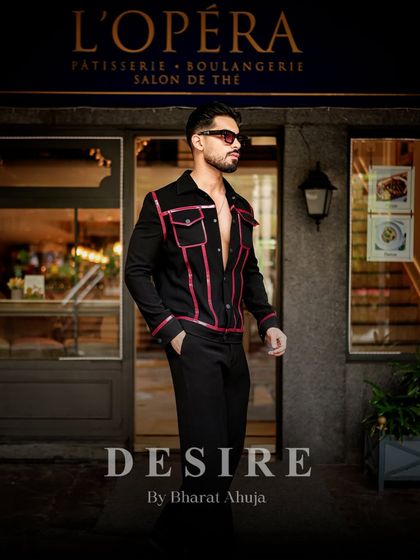 Walking with elegance and an edge. The black and red piped jacket creates a sharp silhouette that is perfect for making a statement.