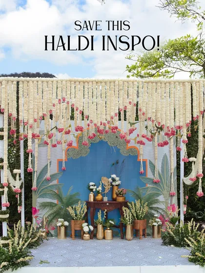 A stunning Haldi backdrop featuring a cascade of white and pink tuberoses over a hand-painted tropical mural. This setup is a perfect example of how I blend floral design with artistic elements.