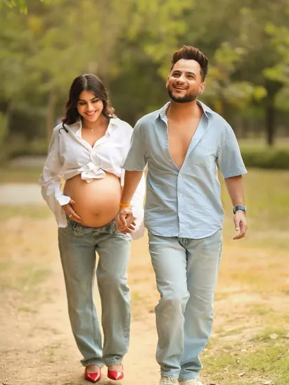 A candid walking shot of the happy couple, Pria and Millind, enjoying their outdoor maternity session.