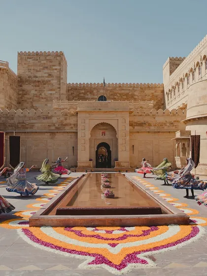 We infuse every celebration with the vibrant culture of the destination. This welcome performance by traditional Rajasthani dancers, set against a beautiful floral rangoli, created an unforgettable arrival experience for guests at Suryagarh.