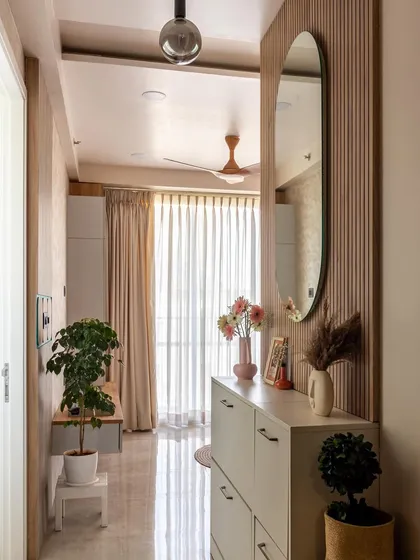 A different angle of the foyer, showing how the natural light from the living area reflects to make the entryway feel bright and spacious.