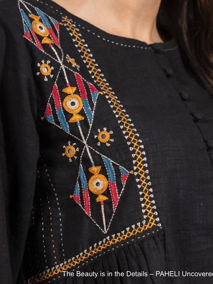 The beauty is in the details. This close-up of a Paheli top shows the bold, colorful Pakka embroidery, a little thing that makes a big statement.