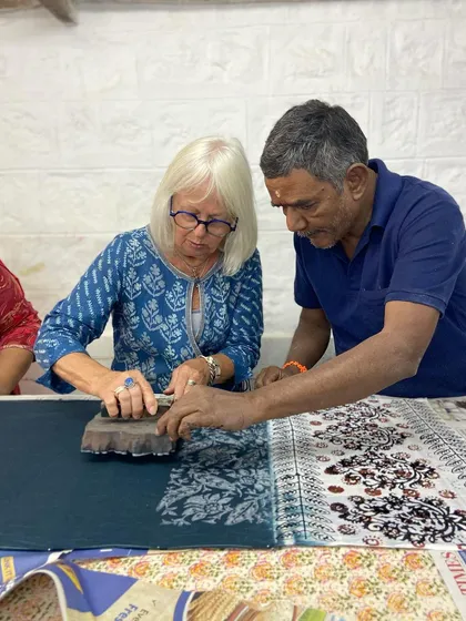 Our workshops are built on personal guidance and shared knowledge. Here, one of our master artisans guides a participant, ensuring she finds her rhythm. It's a collaborative process, where decades of experience meet fresh curiosity.