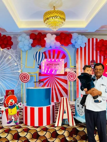A guest enjoying the grand carnival setup, showcasing the scale and detail of the stage decor.