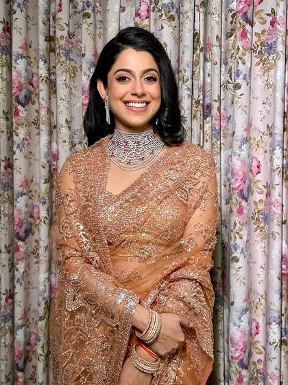 Elegance with a touch of vintage charm. For her cocktail event, this stunning bride embraced a look as timeless as her grace with flushed cheeks, a flicked eyeliner, and a classic retro hairstyle.