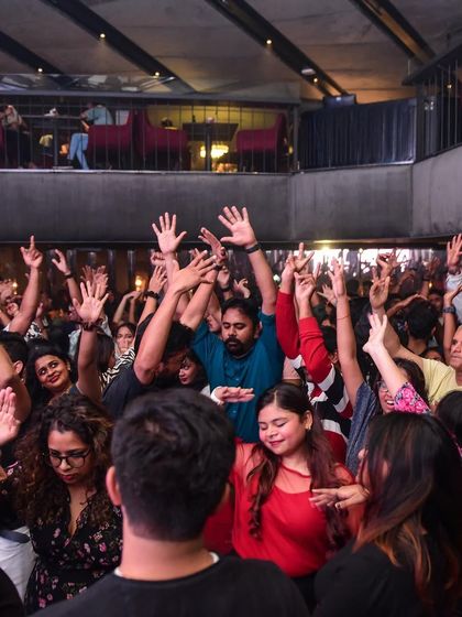 The crowd with their hands up, responding to a drop.