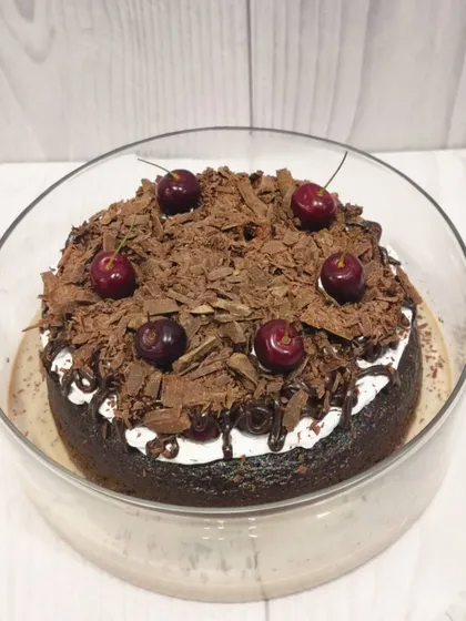 My take on a classic, this is the Black Forest Tres Leches. It features a rich chocolate sponge soaked in my signature milk blend, layered with cream, and topped with chocolate shavings and fresh cherries.