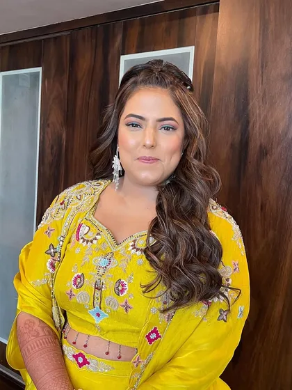 This client looks radiant and ready for her cocktail party. The half updo with voluminous waves is a classic choice that never goes out of style.