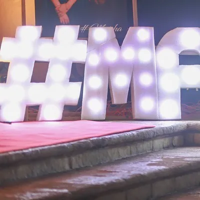 Large, illuminated marquee letters are a great way to personalize your event space. Here, we created the couple's custom hashtag in bold letters at the entrance of their reception.