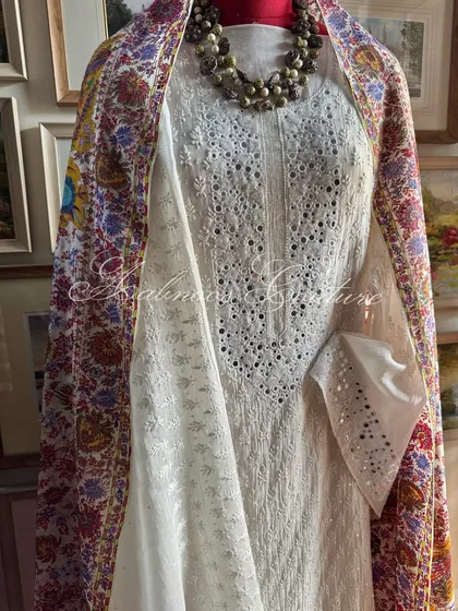 A side view of the mannequin, showing the drape of the colorful dupatta.