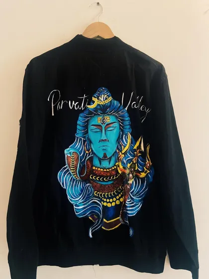 A custom hand-painted jacket featuring a powerful depiction of Lord Shiva for Parvati Valley. This is a great example of how we can merge spiritual art with fashion.
