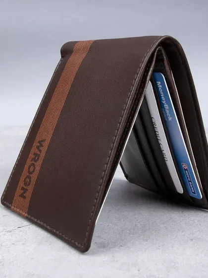 A standing shot of the striped 'WROGN' wallet, showing cards inside.