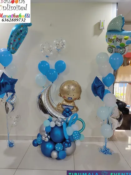 Welcome the new baby boy with our elaborate standing balloon bouquets. This arrangement includes multiple bouquets with 'It's a Boy' themed foils like a baby carriage and a central piece featuring a baby-on-the-moon foil.