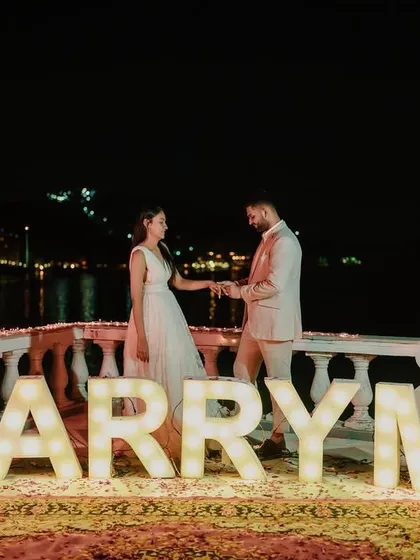 We help you start your forever story with a moment that will be cherished for a lifetime. This surprise proposal we planned by the lake, with illuminated "MARRY ME" letters, created the perfect romantic ambiance for a resounding "Yes!".